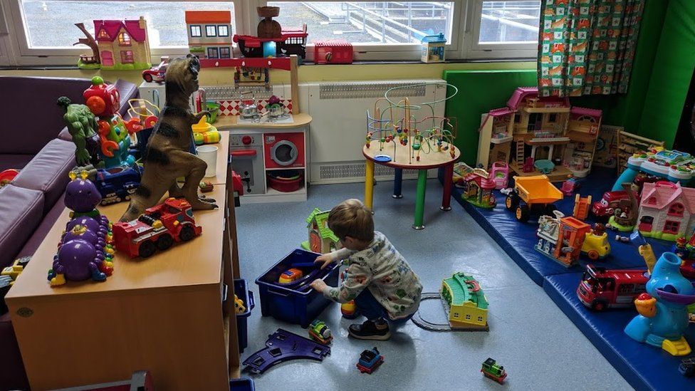 A child playing in a hospital play room