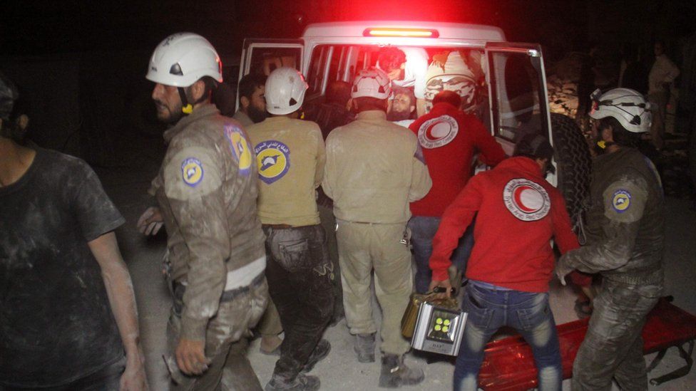 Members of the Syrian Arab Red Crescent and Civil Defence help a wounded victim into the back of an ambulance following Russian air strikes that targeted many areas in Idlib, Syria, on 31 May