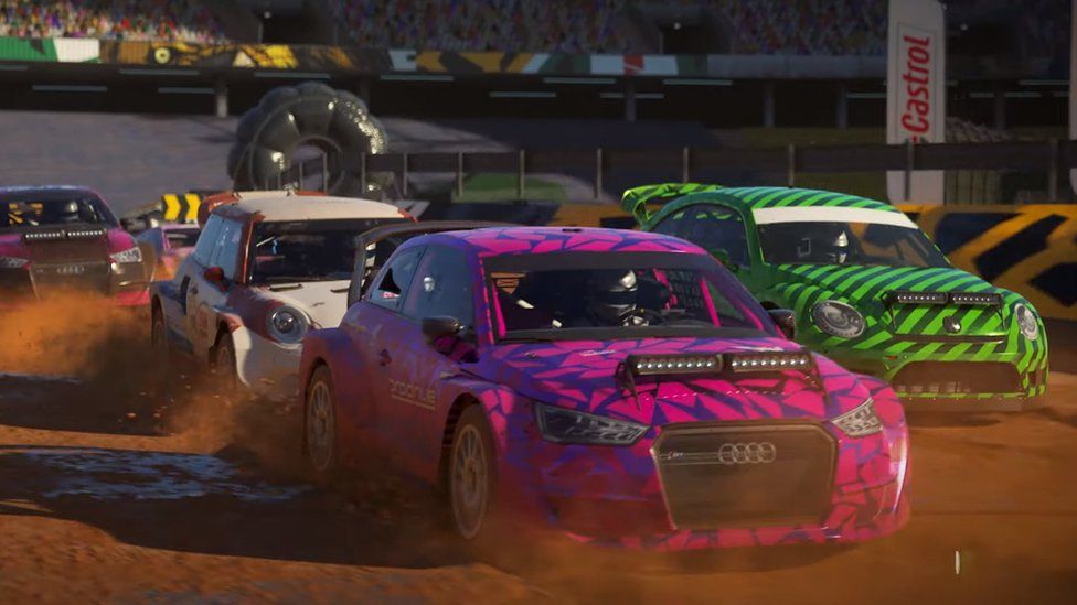 Rally cars go around a dirt track in this trailer screenshot for Dirt 5