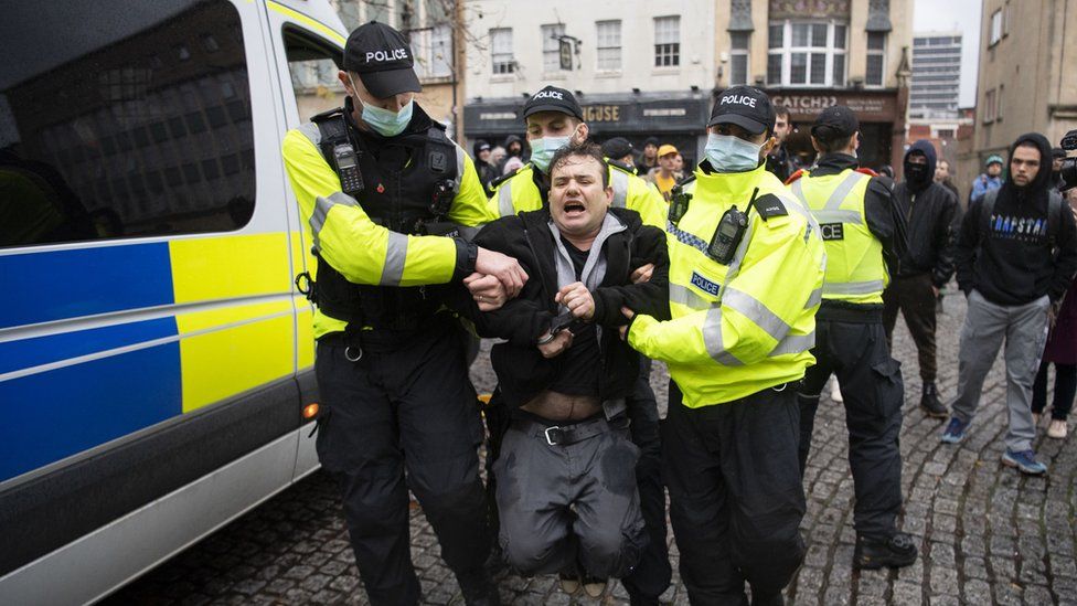 Police arrest a man at the anti-lockdown protest in Bristol