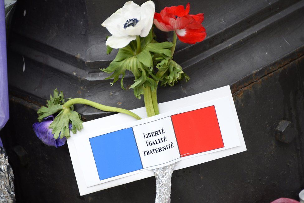 Flower and note left after Paris attacks