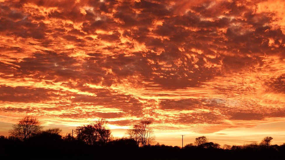 Skies over parts of UK turn 'fiery' red in rare sunset phenomenon