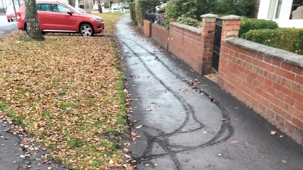 Footprints left in wet tar after workers fail to rope off pavement