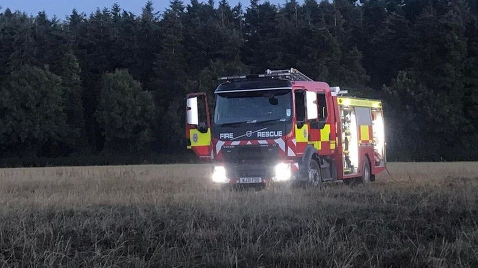 A fire engine in a field