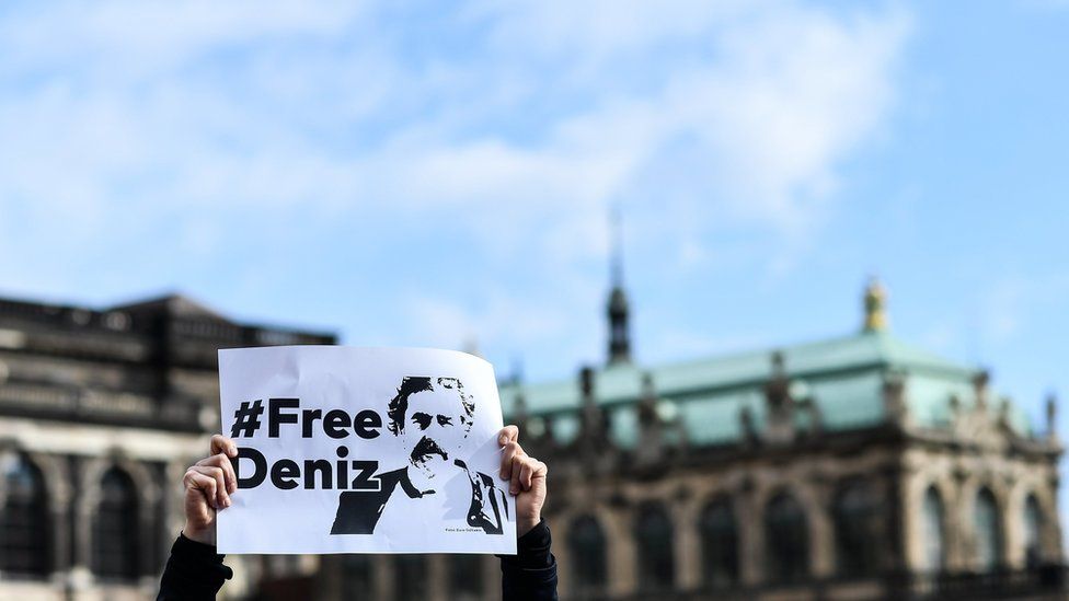 A protestors holds a sign reading "Free Deniz" during a protest on the occasion of the solidarity for the German-Turkish journalist Deniz Yucel, at yard of Zwinger palace in Dresden, Germany, 02 March 201