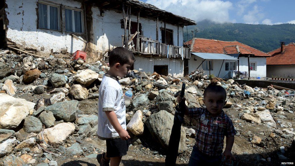 Boys stand on a street in the flooded village of Sipkovica, near the town of Tetovo, Macedonia, 4 August 2015