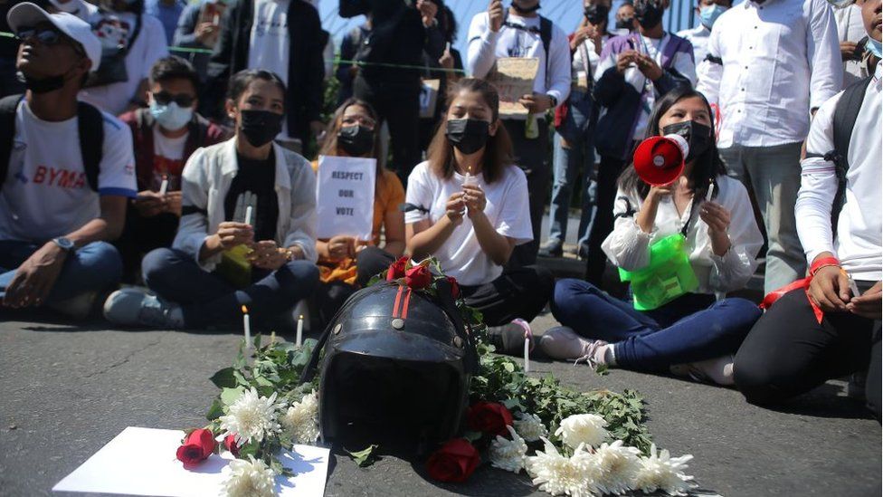 People offer candles and flowers for the teenager who was shot on Tuesday