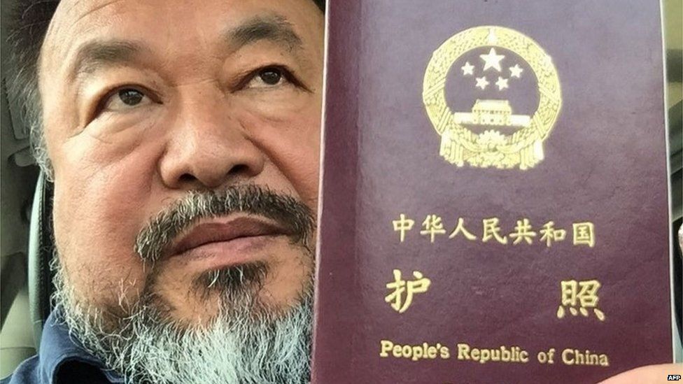 This handout picture released by Chinese dissident artist Ai Weiwei on July 22, 2015 shows Ai Weiwei posing with his passport in Beijing.