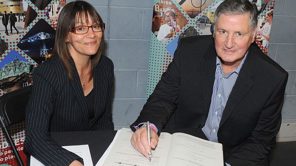 Jim Platt (right) signs the declaration of the acceptance of office in the company of Middlesbrough Council's head of legal services, Samantha Dorchell, following his election