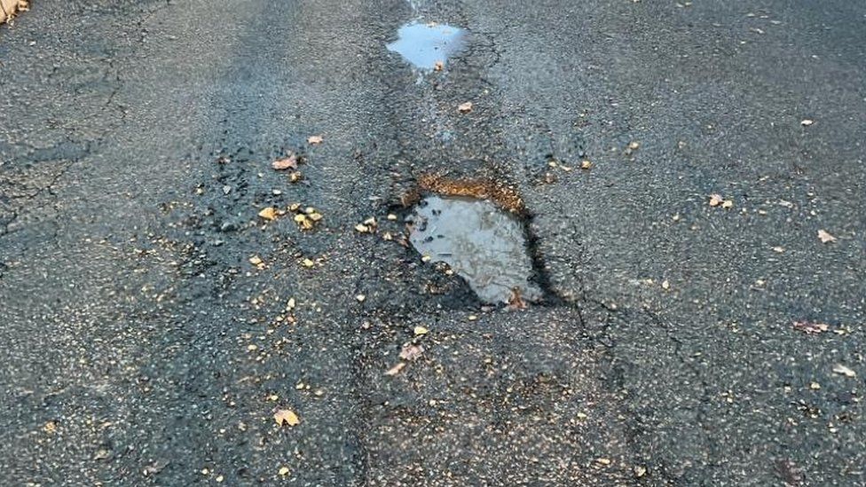 Deep and poorly repaired potholes in Ridge Way, Edenbridge
