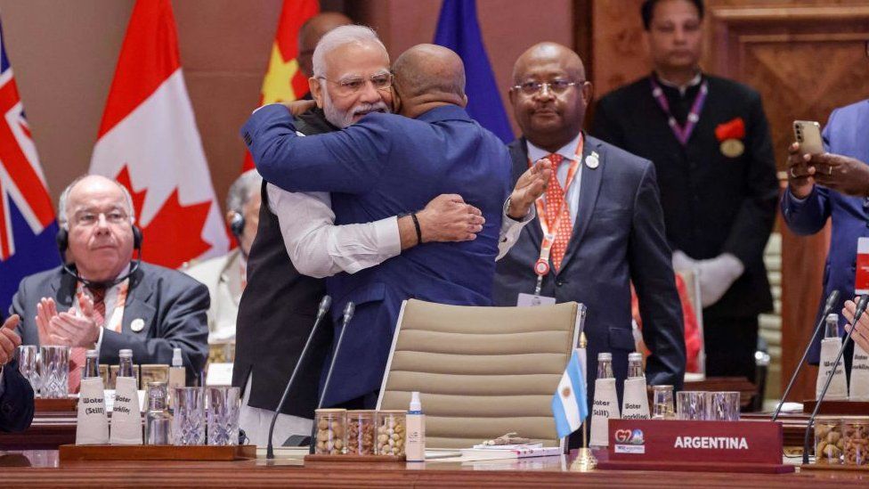African Union Chairman and Comoros President Azali Assoumani (R) and India's Prime Minister Narendra Modi hug each other during the first session of the G20 Leaders' Summit at the Bharat Mandapam in New Delhi on September 9, 2023. (Photo by Ludovic MARIN / POOL / AFP) (Photo by LUDOVIC MARIN/POOL/AFP via Getty Images)