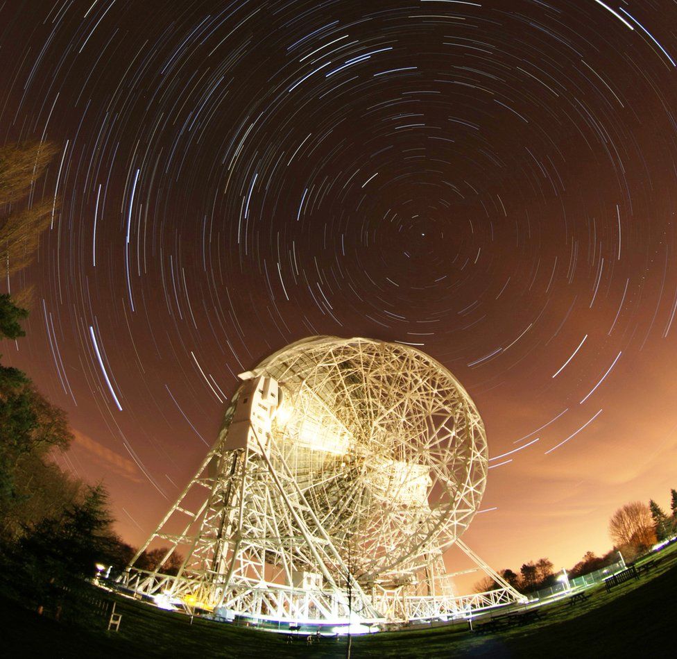 timelapse still of star trails behind the Lovell Telescope