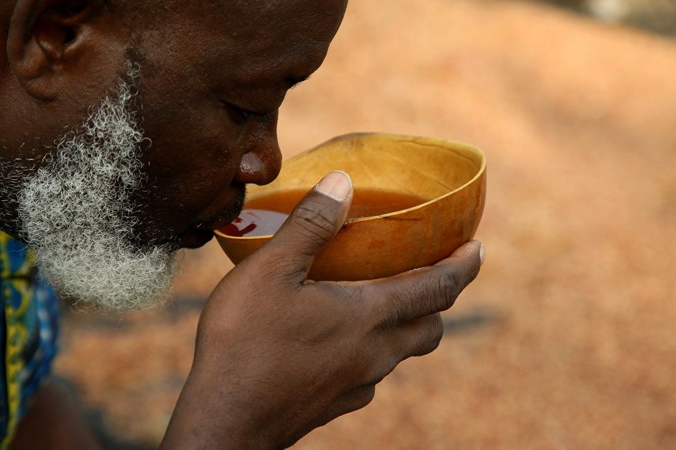 A man drinks from a calabash.