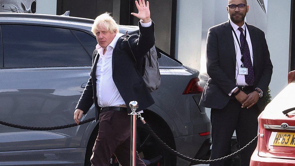 Former British Prime Minister Boris Johnson gestures, at Gatwick Airport,