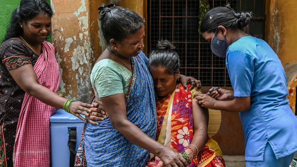 A health worker inoculates a beneficiary with the dose of Covaxin vaccine against the Covid-19 coronavirus during a door to door vaccination campaign at a residential area in Chennai on October 19, 2021