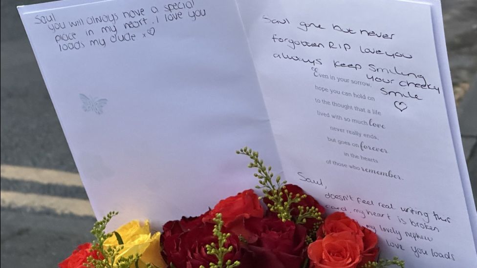 Flowers and sympathy card left at crash scene