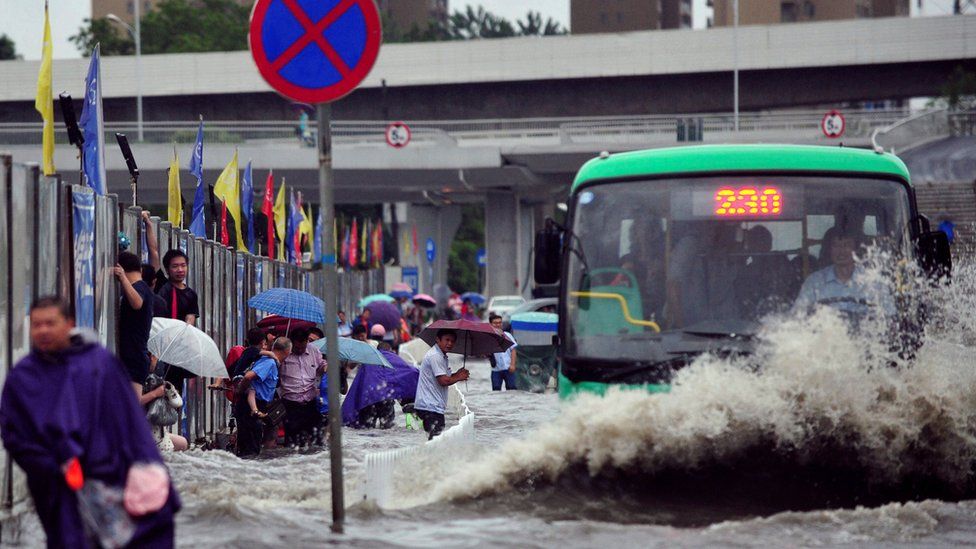 A bus splashes through the street in Wuhan