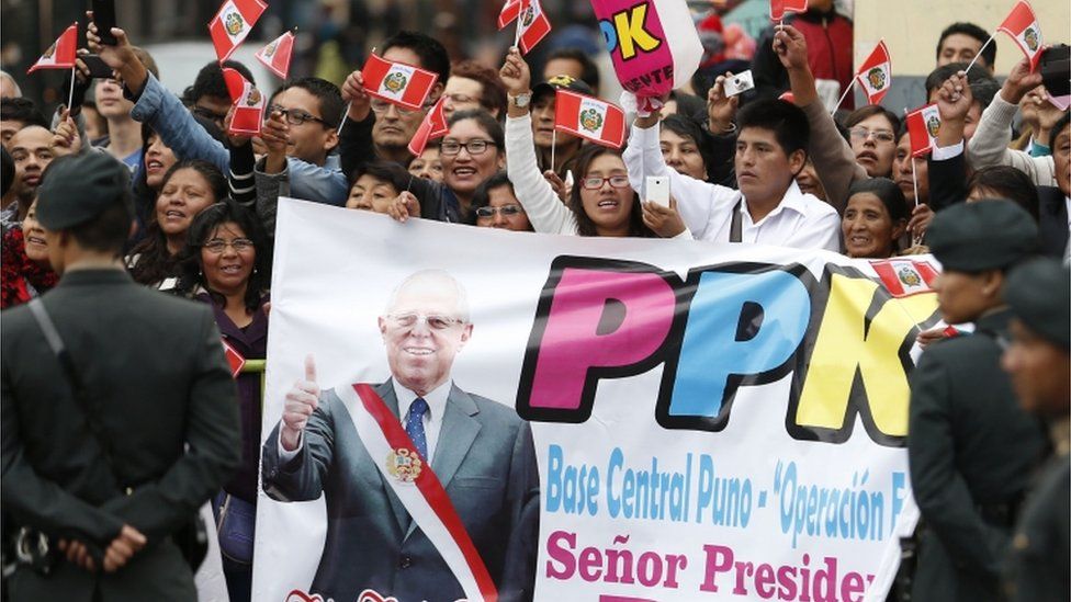 Supporters of Peru's president Pedro Pablo Kuczynski wave flags in the streets