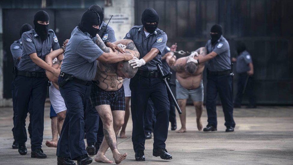 Gang members being arrested by police