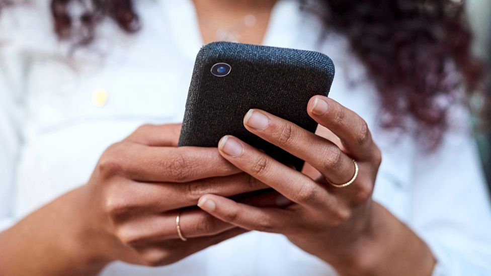 Stock image of a woman's hands holding a smartphone