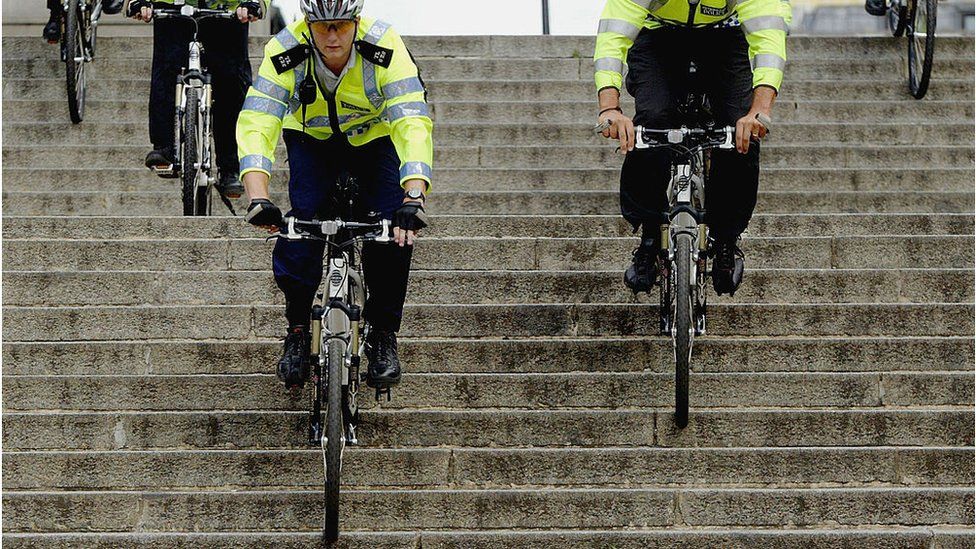 LONDON - JULY 1: Transport officers cycle down a set of stairs on their bikes July 1, 2004 in London. The Transport Command Unit (OCU) today celebrated its second birthday. Transport officers have deterred and tackled anti-social behavior and kept traffic moving in bus corridors and at transport interchanges. (Photo by Graeme Robertson/Getty Images) *** Local Caption ***