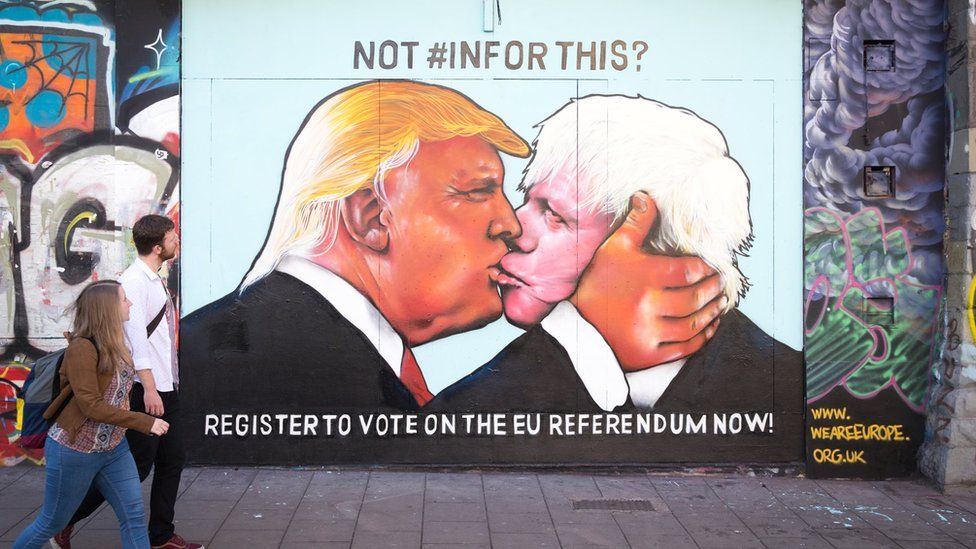 Donald Trump and Boris Johnson embrace depicted in Bristol street art