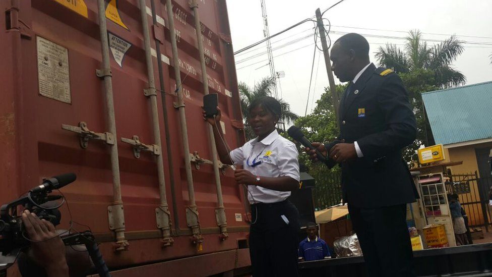 Custom official and man stand next to a cargo truck