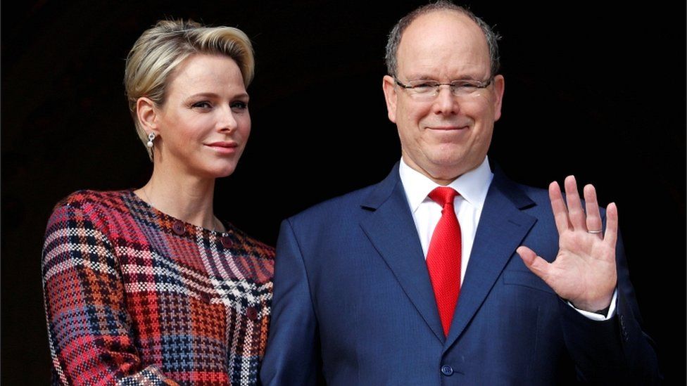 Prince Albert II of Monaco and his wife Princess Charlene stand on the palace balcony in Monaco on 27 January 2018