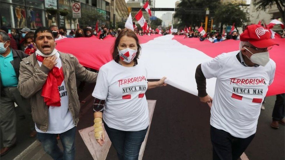 People wearing shirts reading "Terrorism never again" gather to commemorate the 29th anniversary of the capture of Abimael Guzman, founder of Peruvian rebel group Sendero Luminoso (Shining Path), who died on September 11 at the Callao Naval Base where he was serving a life sentence, in Lima, Peru, September 12, 2021.