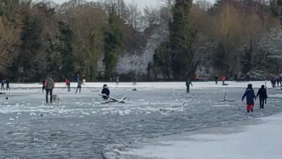 People playing on ice in Verulamium Park, St Albans