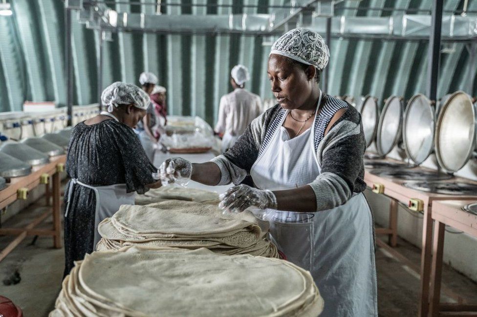 Women work making injera at Lemi Kura Injera Factory in Addis Ababa, Ethiopia, 1 September.
