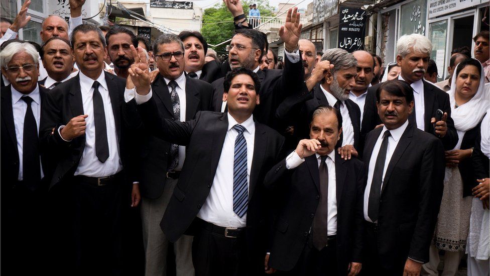 Lawyers chant slogans condemning the bombing