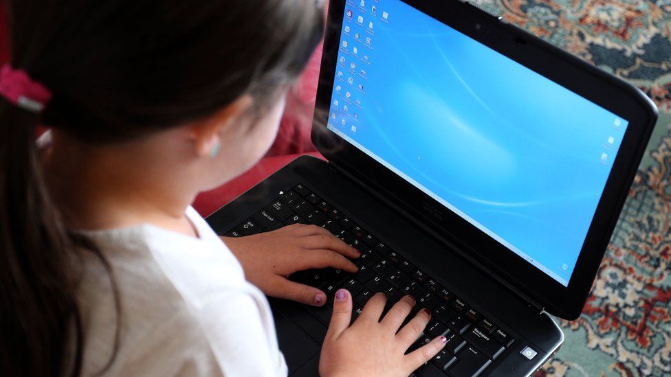 Ребенок с помощью портативного компьютера