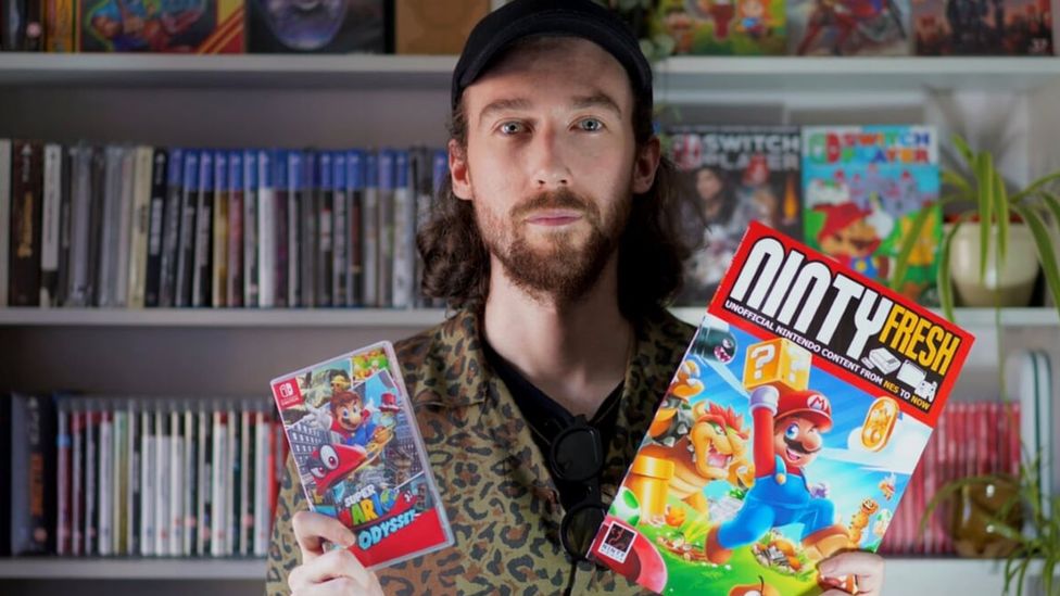 Jon with Mario's latest adventure, Super Mario Odyssey and a Nintendo magazine
