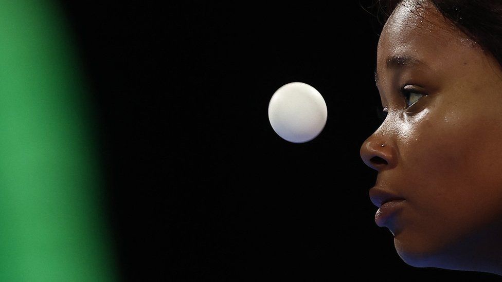 A close up of Zodwa Maphangain staring intently at a ping pong ball.