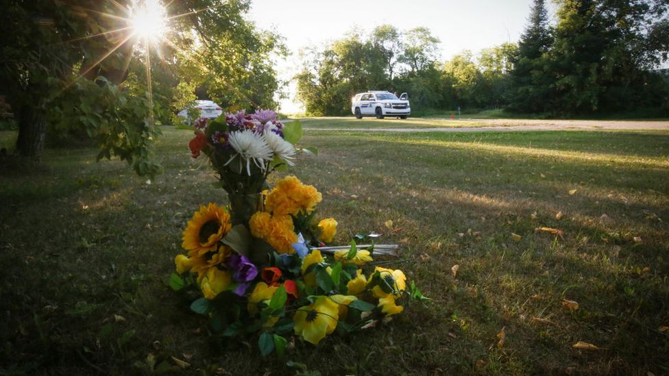 Flowers sit outside the house where one of the stabbing victims was found in Weldon, Saskatchewan, Canada, on September 6, 2022