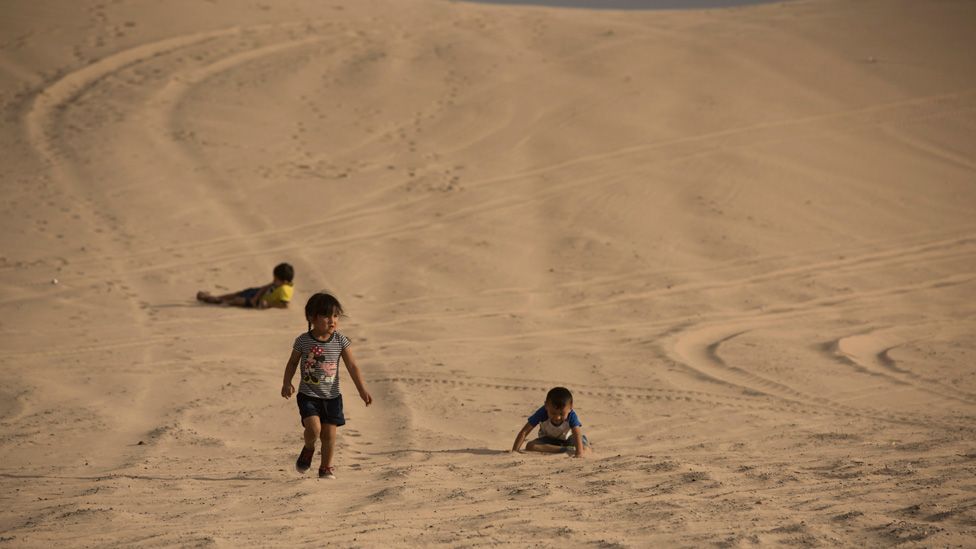 Children play in the dunes