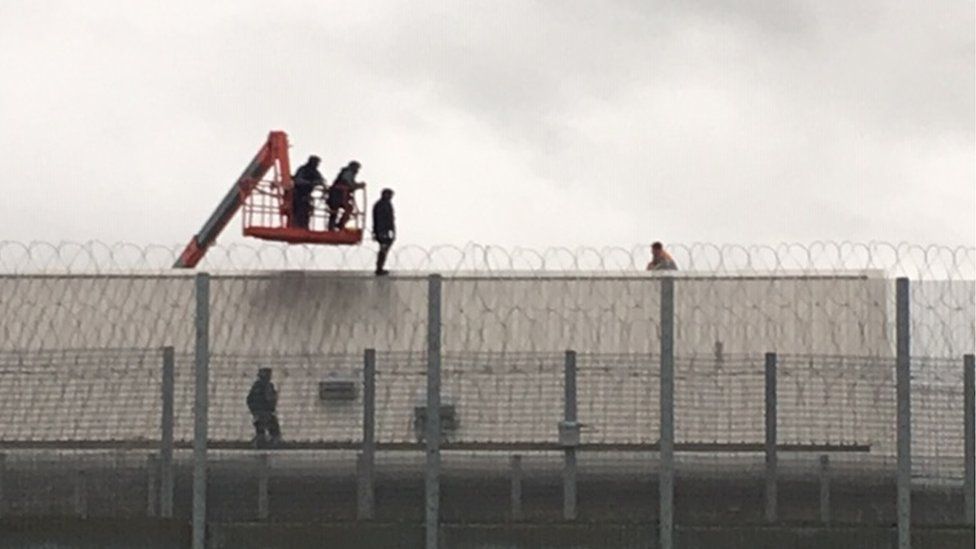 A prisoner on the roof at HMP Berwyn