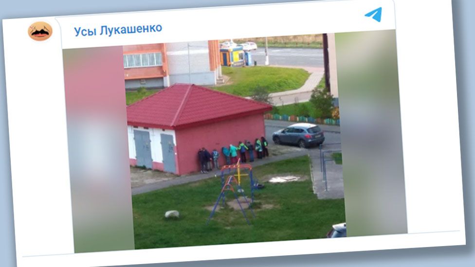 Telegram video showing Belarusian children standing behind an electrical substation, facing a wall and holding their hands behind their backs