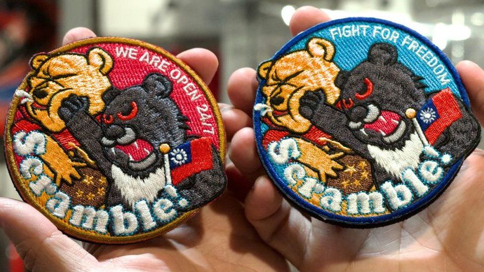 Sew-on patches showing a Taiwanese black bear punching Winnie the Pooh