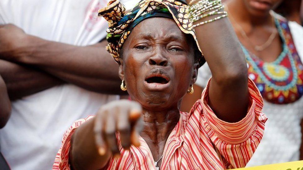 A mother who lost her son during the mudslide reacts near the entrance of Connaught Hospital in Freetown, Sierra Leone August 16, 2017.