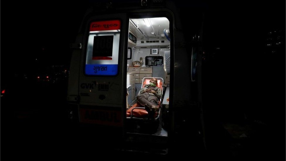 A patient lies inside an ambulance waiting in a queue to enter a COVID-19 hospital, amidst the spread of the coronavirus disease (COVID-19) in Ahmedabad, India, April 14, 2021