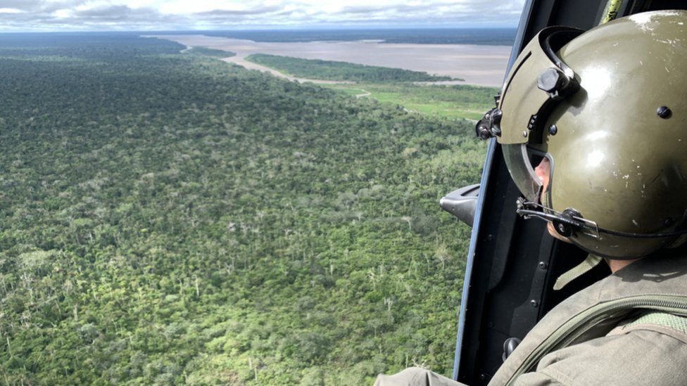 Brazilian search team flies over the Amazon.