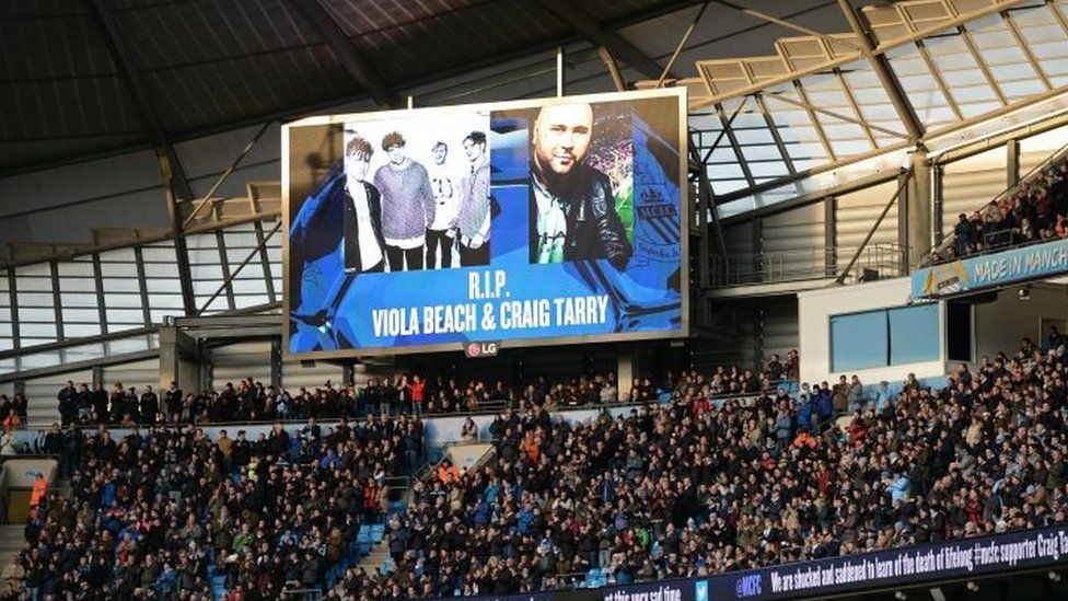 Photographs of the members of the band Viola Beach and their manager Craig Tarry is displayed on a screen ahead of the Premier League football match between Manchester City and Tottenham Hotspur at the Etihad Stadium in Manchester