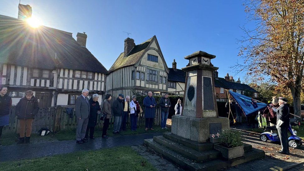 The minute's silence is observed at a ceremony in the village of Headcorn, near Maidstone, Kent