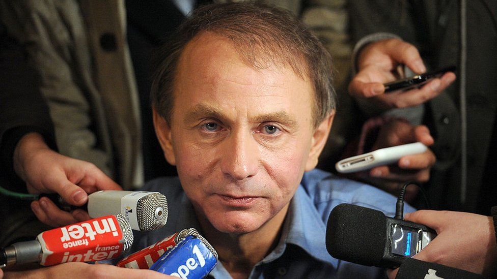 Michel Houellebecq surrounded by journalists after receiving the 2010 Goncourt Prize