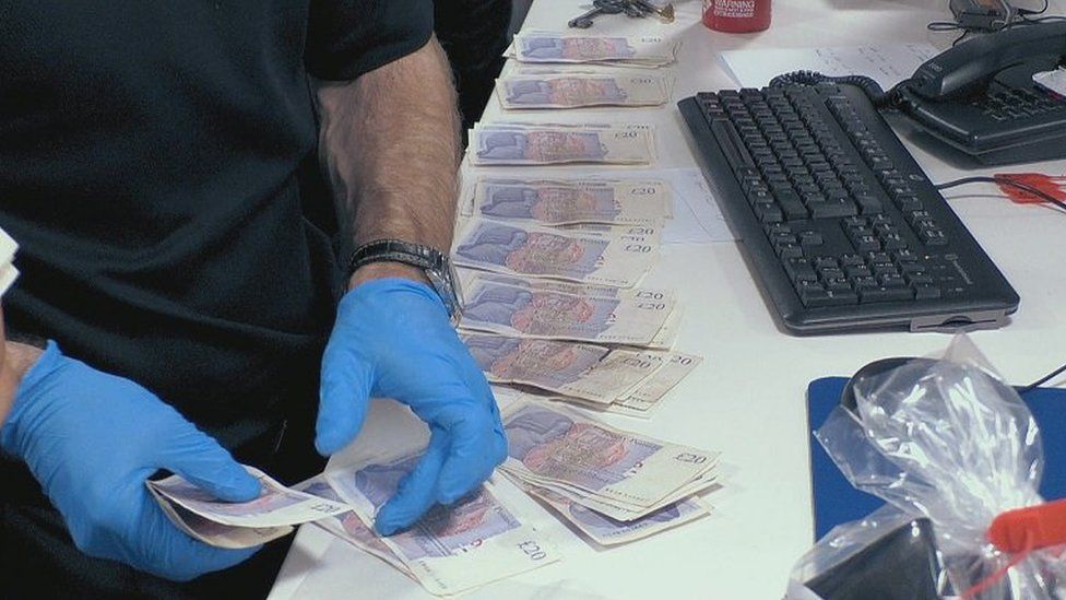 Police inspect cash haul