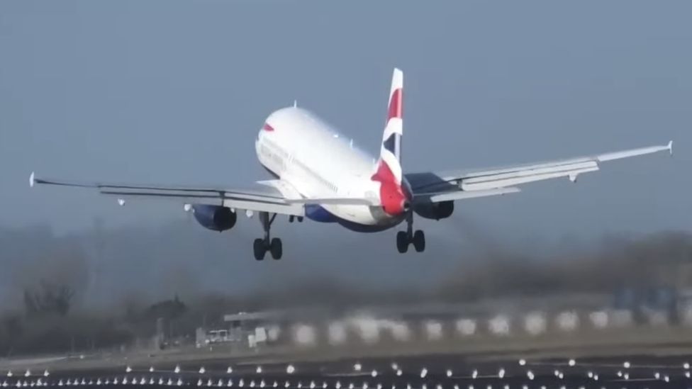 A British Airways plane flies away after a failed attempt to land at London's Heathrow Airport