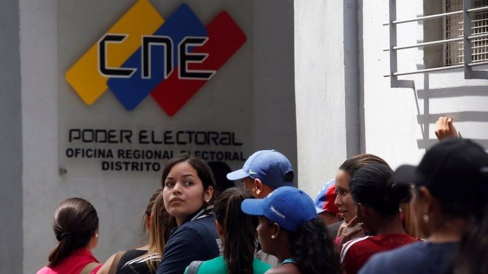 People gather outside a validation centre during Venezuela's CNE second phase of verifying signatures for a recall referendum against President Maduro, in Caracas, Venezuela, June 24, 2016.