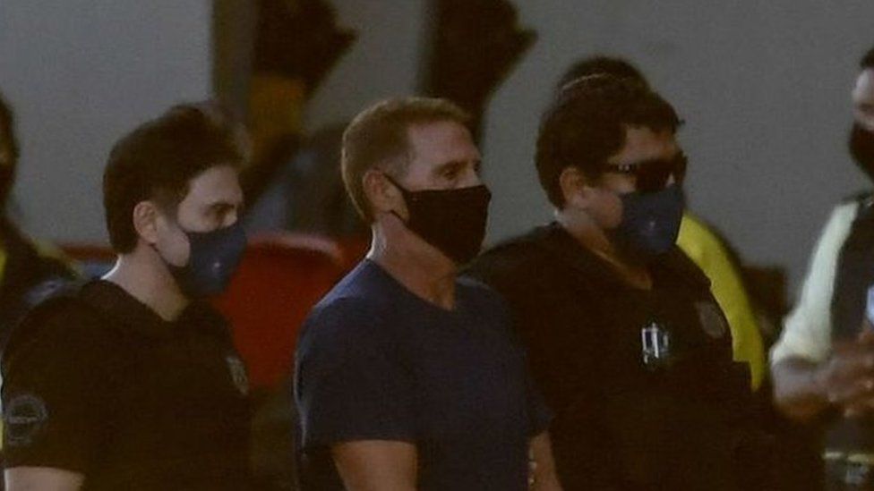 Rocco Morabito (c) being escorted off a plane in Brasilia